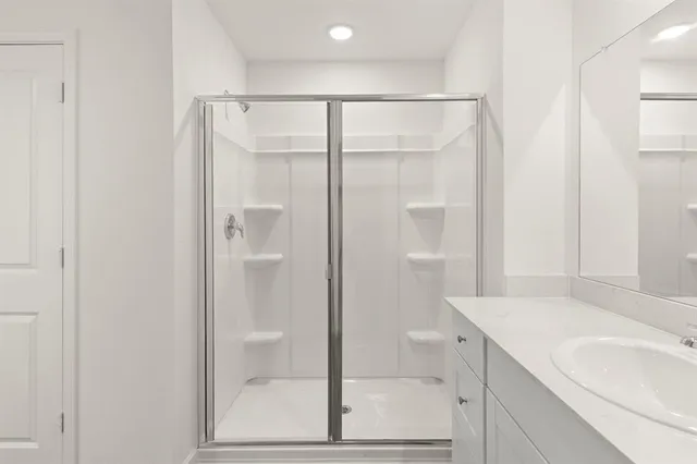 a bathroom with a shower and a sink