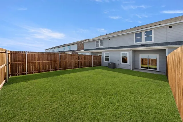 a front view of a house with a garden and yard