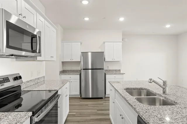 a kitchen with a sink stove and refrigerator