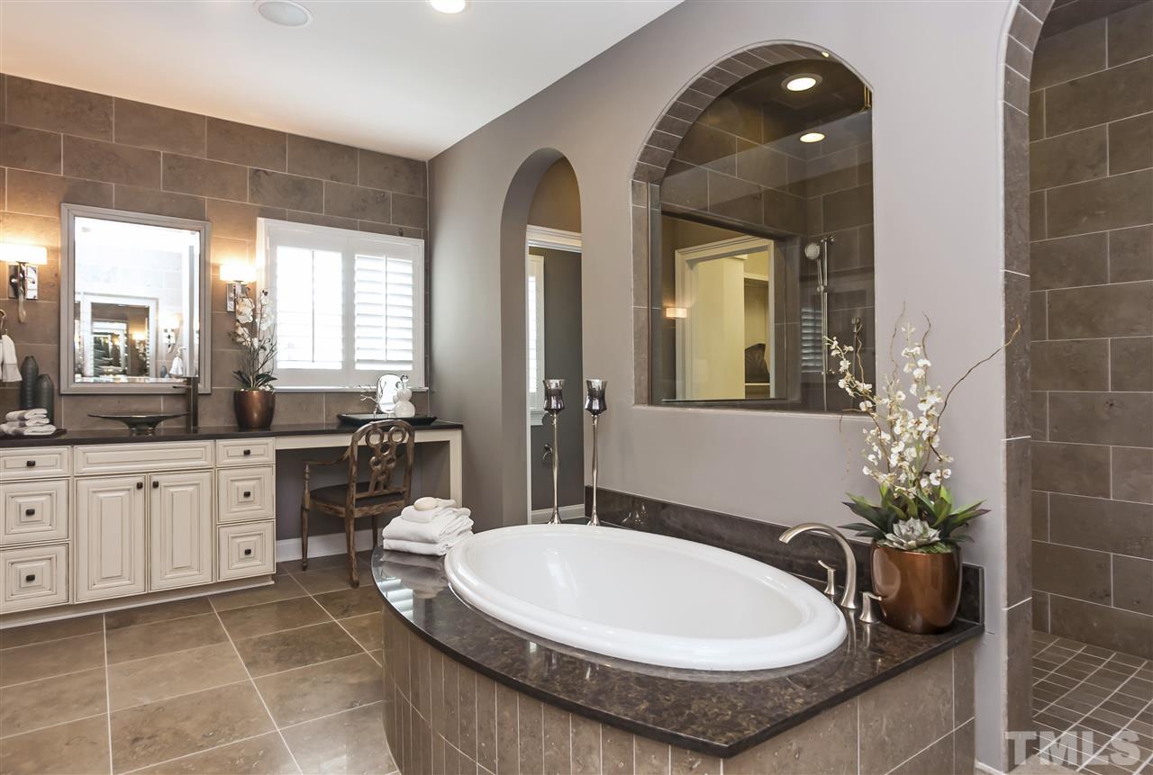 3623 Rolston Drive, Unit 9 Raleigh, NC 27609 - Photo 14 of 25 a bathroom with a tub sink and mirror