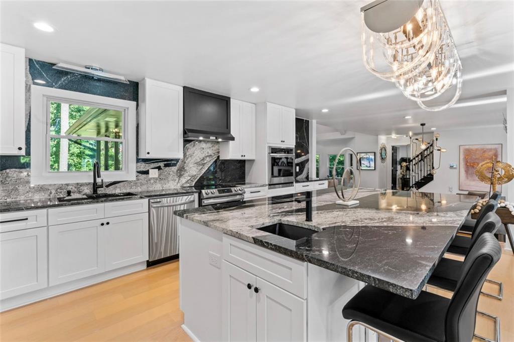 3519 Prince George Street Atlanta, GA 30344 - Photo 15 of 58 a kitchen with stainless steel appliances granite countertop a sink a stove and a counter top space