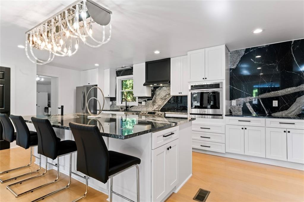 3519 Prince George Street Atlanta, GA 30344 - Photo 17 of 58 a kitchen with stainless steel appliances kitchen island granite countertop a sink and cabinets