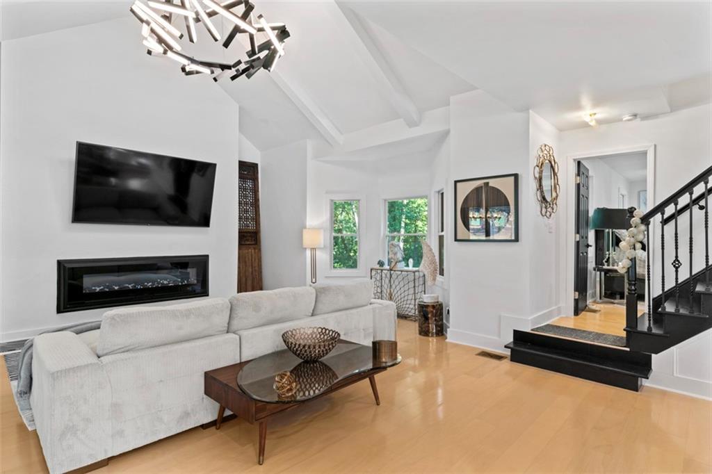 3519 Prince George Street Atlanta, GA 30344 - Photo 21 of 58 a living room with furniture a fireplace and a flat screen tv