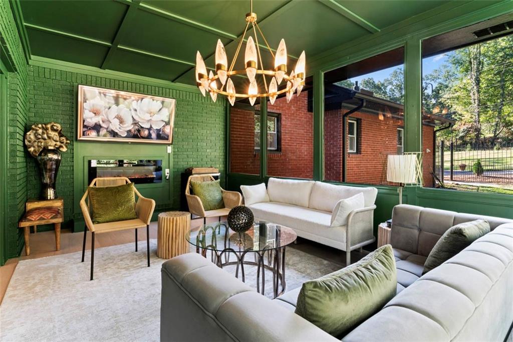 3519 Prince George Street Atlanta, GA 30344 - Photo 25 of 58 a living room with furniture a flat screen tv and a floor to ceiling window