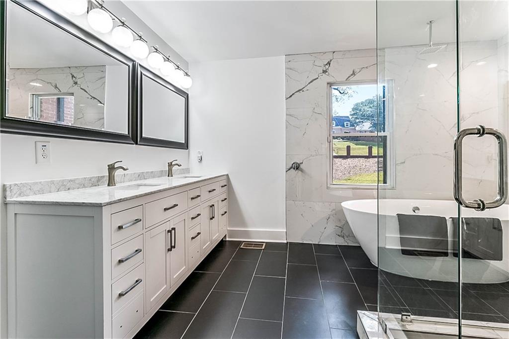 3519 Prince George Street Atlanta, GA 30344 - Photo 30 of 58 a bathroom with a double vanity sink and a mirror