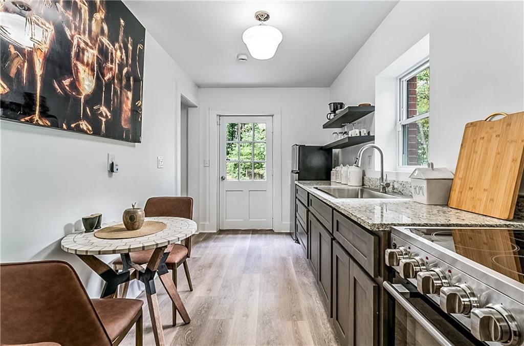 3519 Prince George Street Atlanta, GA 30344 - Photo 45 of 58 a kitchen with stainless steel appliances granite countertop a stove top oven a sink a counter space and dining table