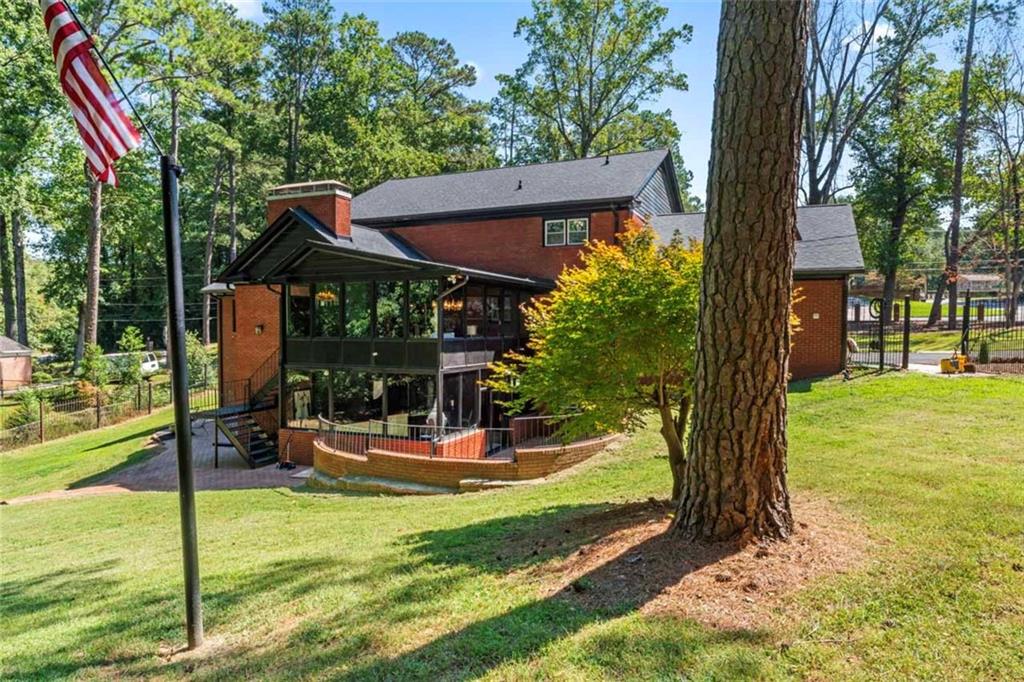 3519 Prince George Street Atlanta, GA 30344 - Photo 53 of 58 a view of a patio with table and chairs potted plants and large tree