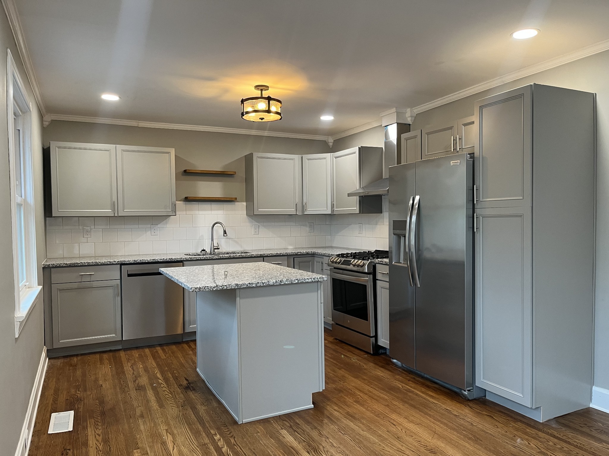 1690 Valley Road Clarksville, TN 37043 - Photo 13 of 16 a kitchen with stainless steel appliances granite countertop a sink stove and refrigerator