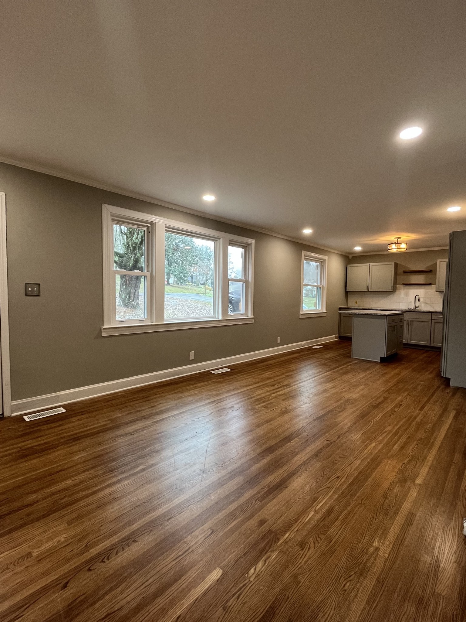 1690 Valley Road Clarksville, TN 37043 - Photo 2 of 16 a view of empty room with kitchen view and wooden floor