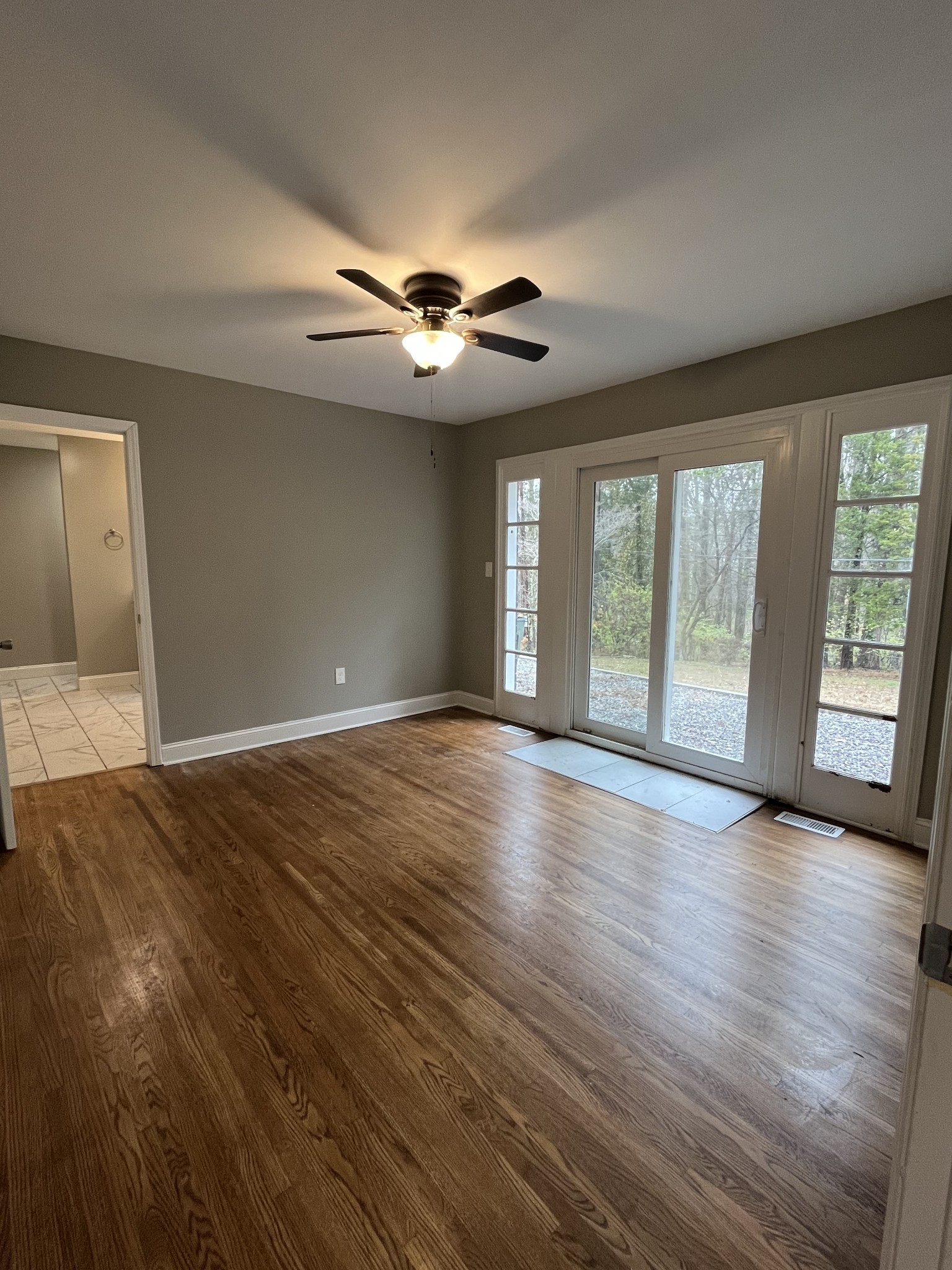 1690 Valley Road Clarksville, TN 37043 - Photo 4 of 16 a view of an empty room with wooden floor and a window