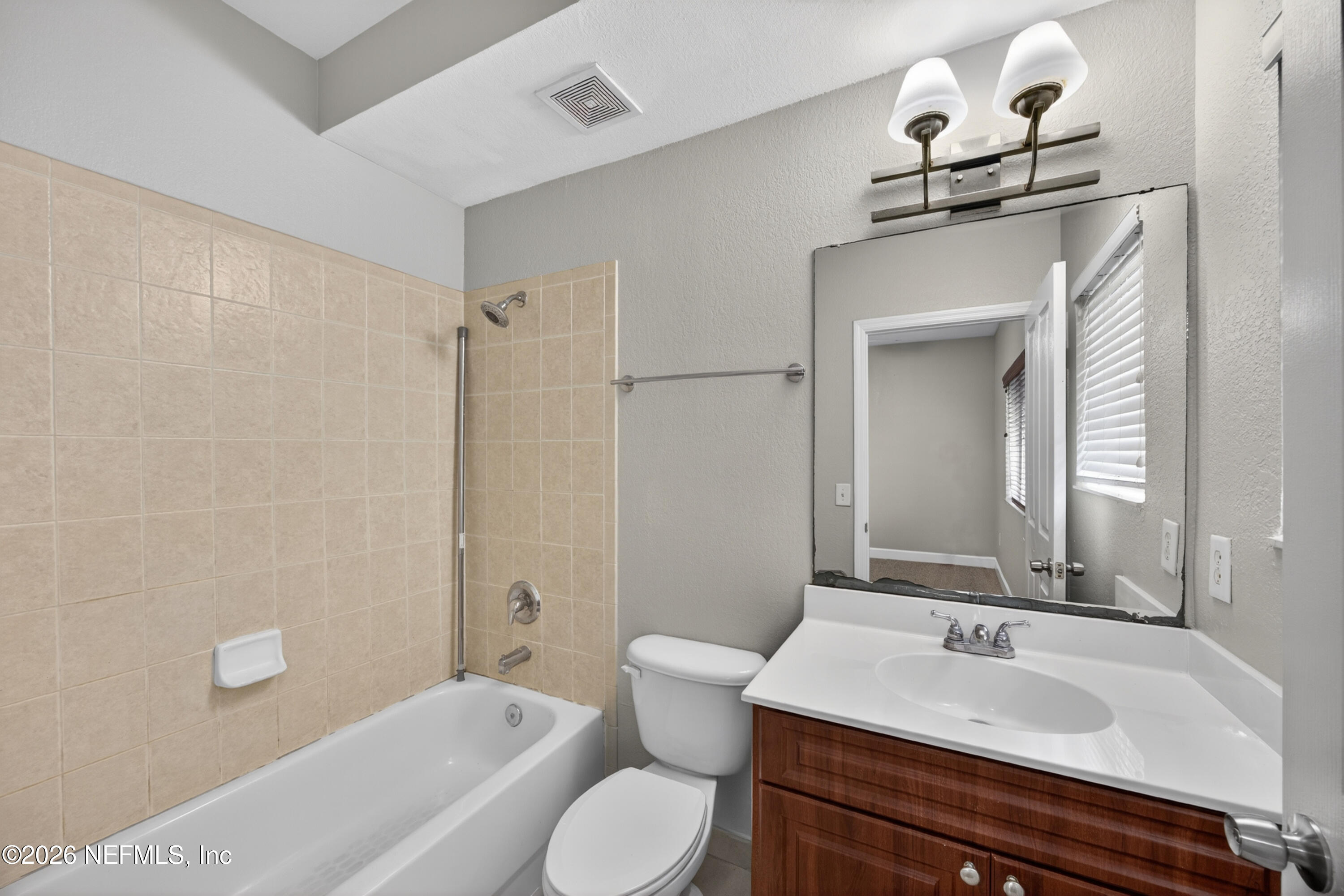 9745 Touchton Road, Unit 1224 Jacksonville, FL 32246 - Photo 19 of 22 a bathroom with a sink toilet and shower