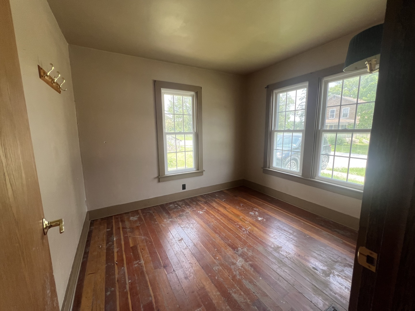 529 North 2nd Street Watseka, IL 60970 - Photo 3 of 16 a view of an empty room with wooden floor and a window