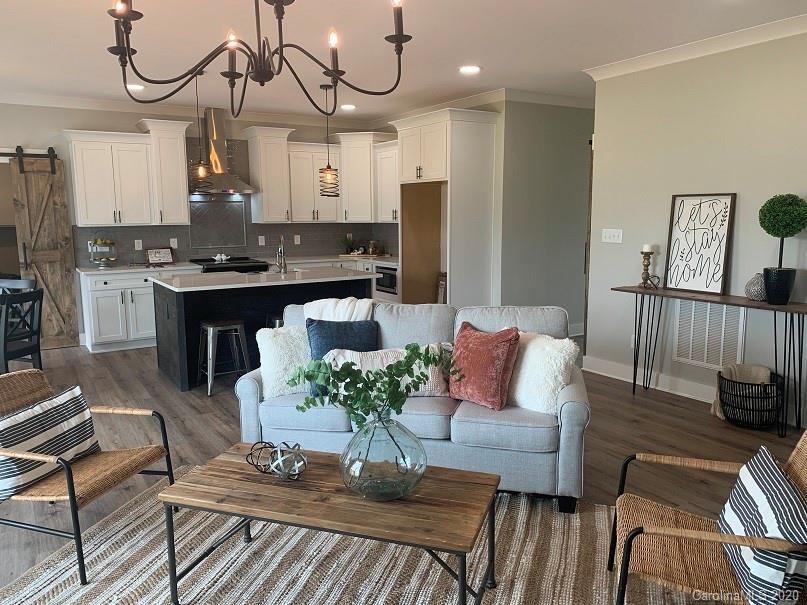 545 Gatton Road Cleveland, NC 27013 - Photo 16 of 27 a living room with furniture kitchen view and a chandelier
