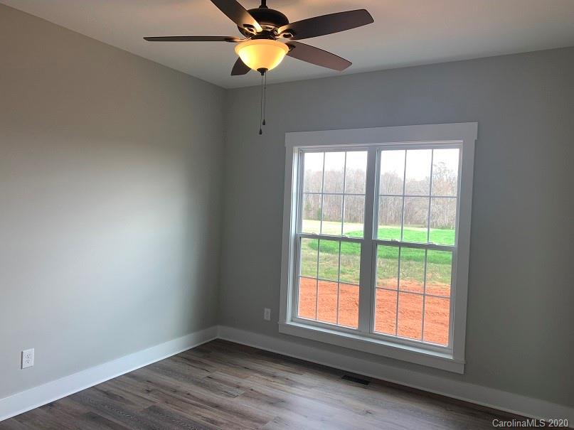 545 Gatton Road Cleveland, NC 27013 - Photo 24 of 27 an empty room with wooden floor and windows