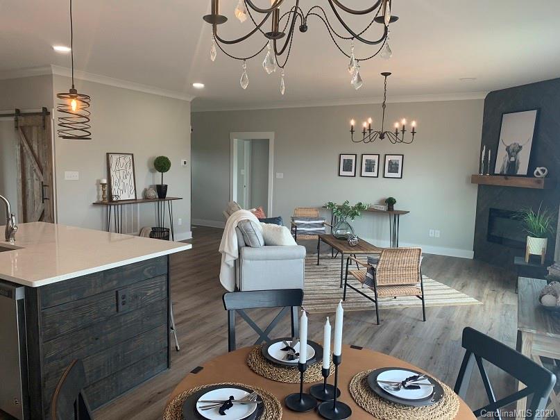 545 Gatton Road Cleveland, NC 27013 - Photo 8 of 27 a view of a dining room with furniture a chandelier and wooden floor