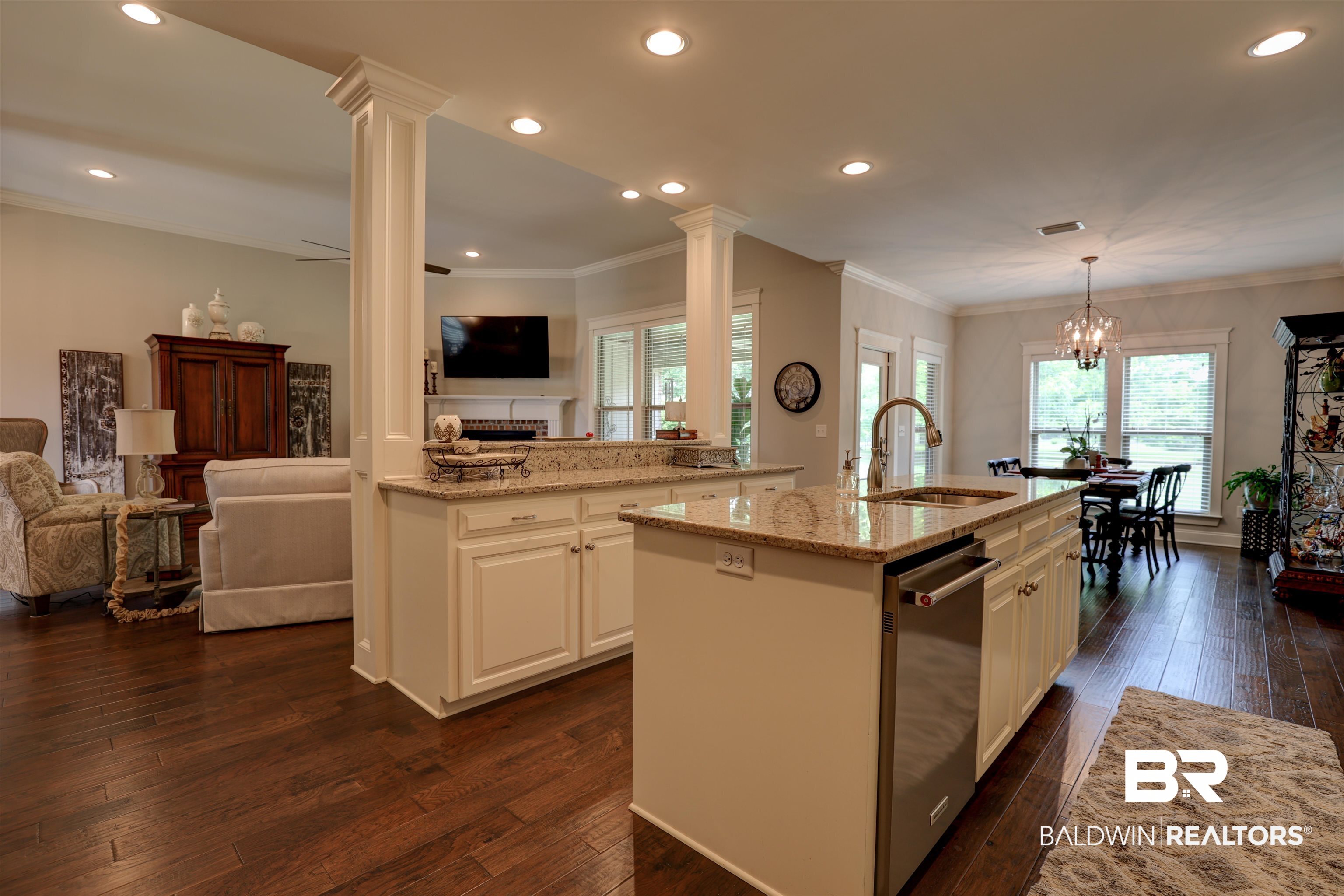 10588 Leesburg Pike Daphne, AL 36526 - Photo 13 of 29 Kitchen featuring sink, dark wood-type flooring, and a center island with sink