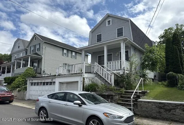 a car parked in front of white house