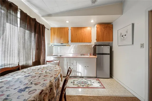 a kitchen with kitchen island sink refrigerator and window