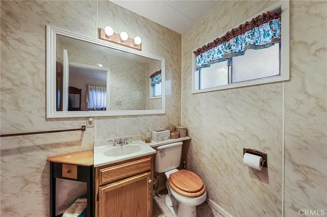 a bathroom with a sink mirror vanity and toilet