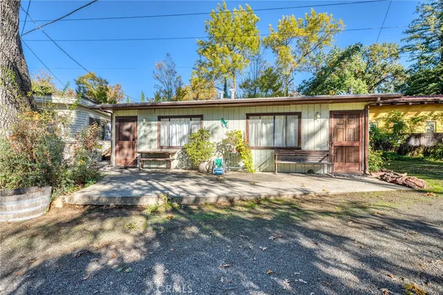 a view of a house with a yard and garden