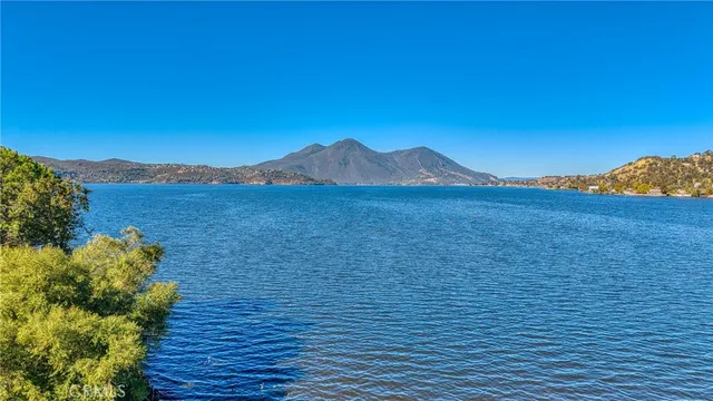 a view of an ocean with a mountain in the background