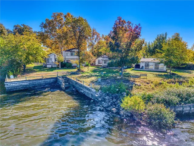 a view of a house with swimming pool and a yard