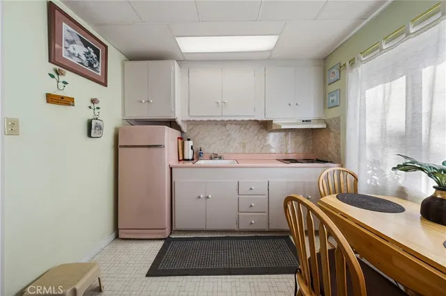 a kitchen with sink refrigerator and window