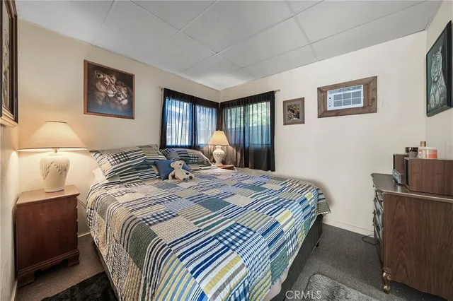 a bedroom with bed and a window