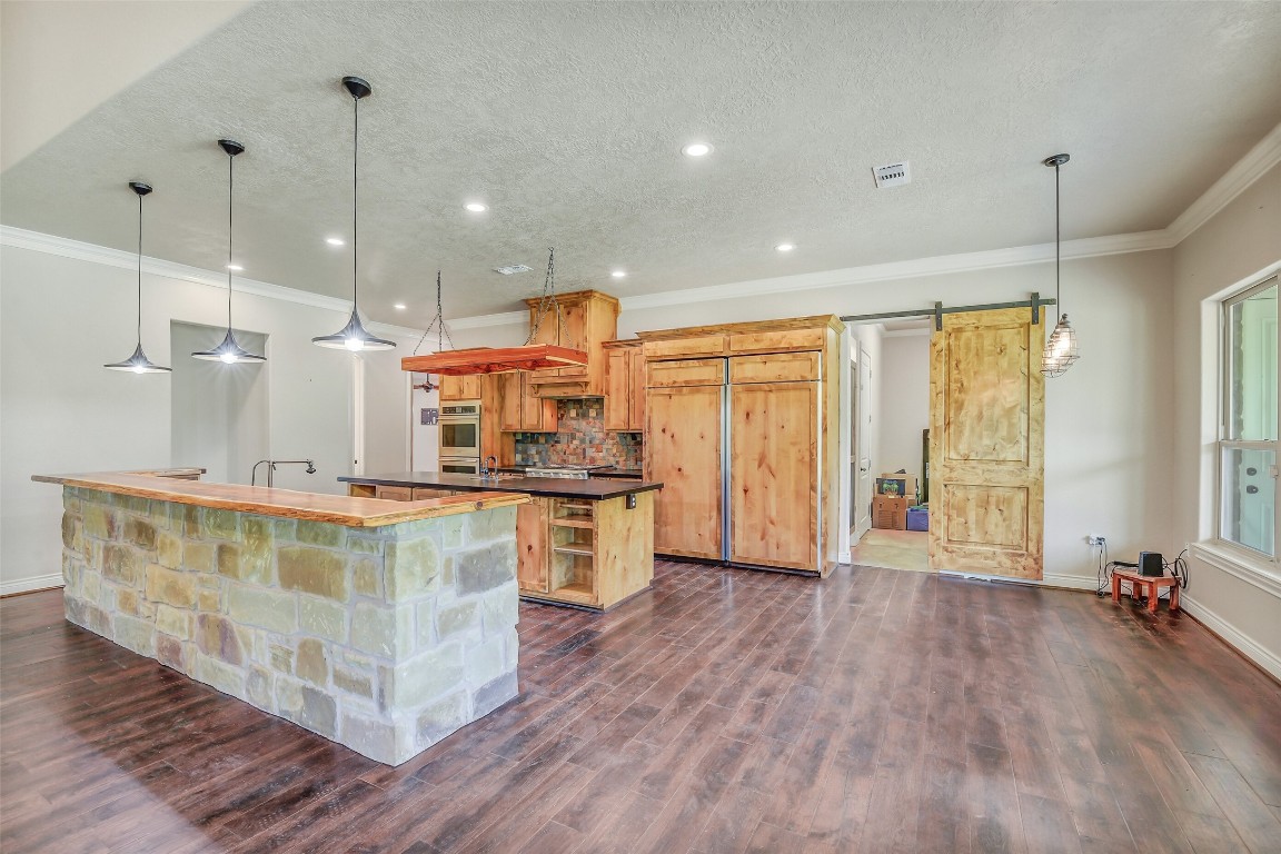 41545 Farm To Market 3346 Hempstead, TX 77445 - Photo 30 of 49 a large kitchen with kitchen island a large counter top stainless steel appliances and wooden floor