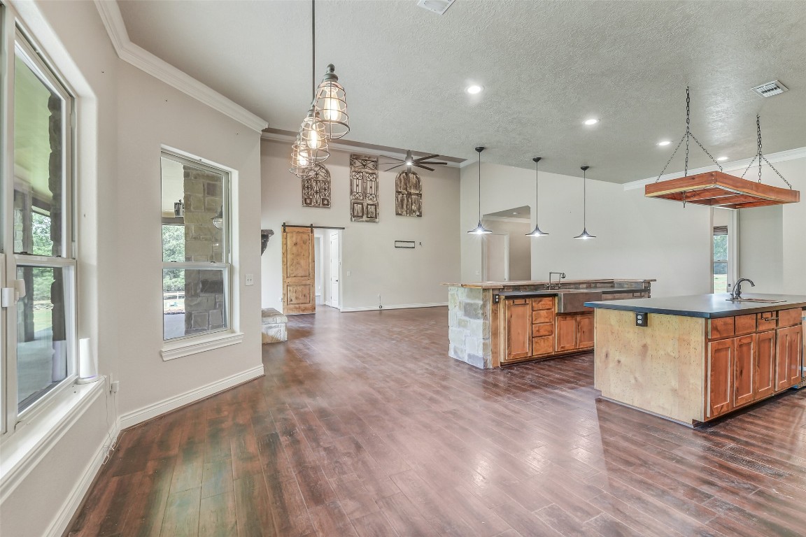 41545 Farm To Market 3346 Hempstead, TX 77445 - Photo 34 of 49 a kitchen with stainless steel appliances kitchen island granite countertop a stove a sink and a refrigerator with wooden floor