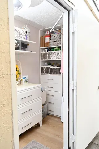 a kitchen with stainless steel appliances granite countertop a table chairs sink refrigerator and cabinets