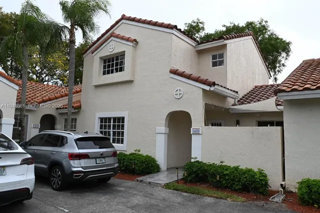 a car parked in front of white house