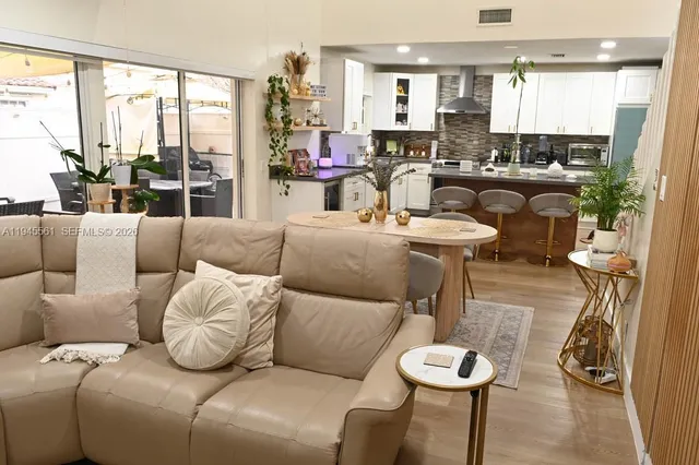 a living room with furniture and flat screen tv