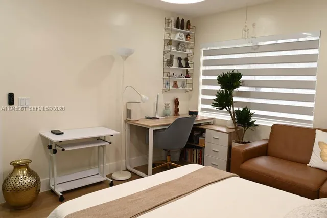 a bedroom with a bed and a television