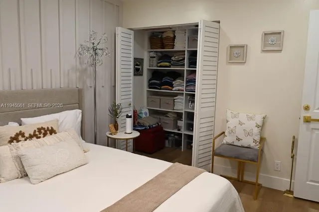 a bedroom with a bed and a chair