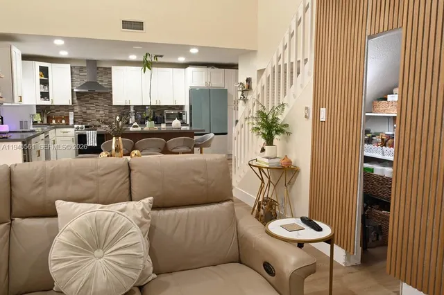 a room with water heater and wooden shelves
