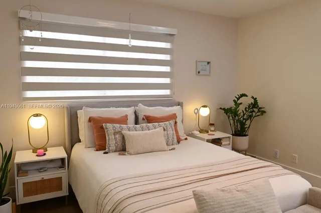 a bathroom with a granite countertop toilet sink and mirror