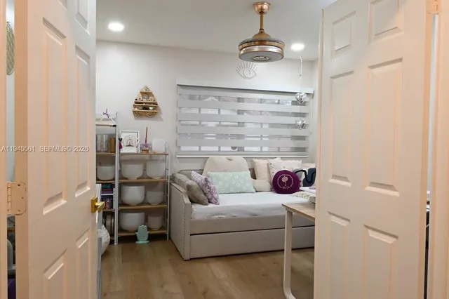 a room with a couch and a view of living room