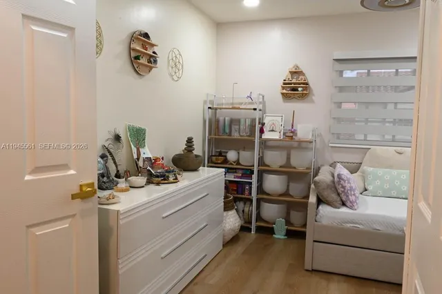 a view of a workspace with furniture and wooden floor