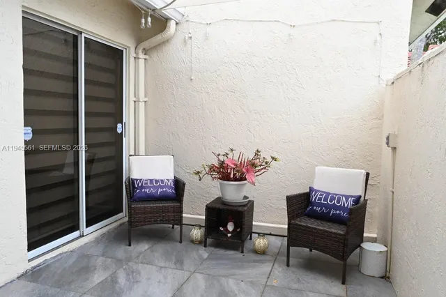 a view of a room with a bench and a potted plant