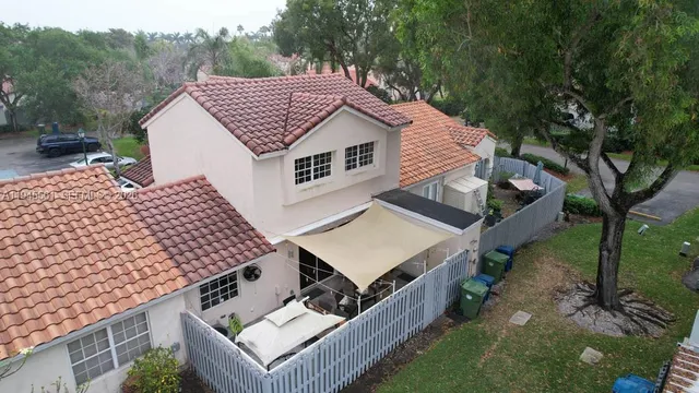 a view of a house with a yard and furniture
