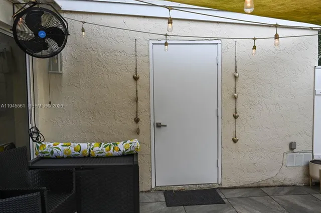 a backyard of a house with table and chairs