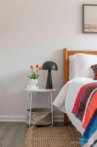 a dining room with furniture a chandelier and wooden floor