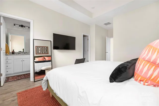 a bedroom with a bed and a couch