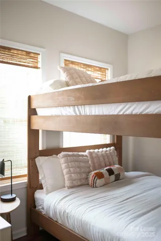 a bedroom with a bed and lamp