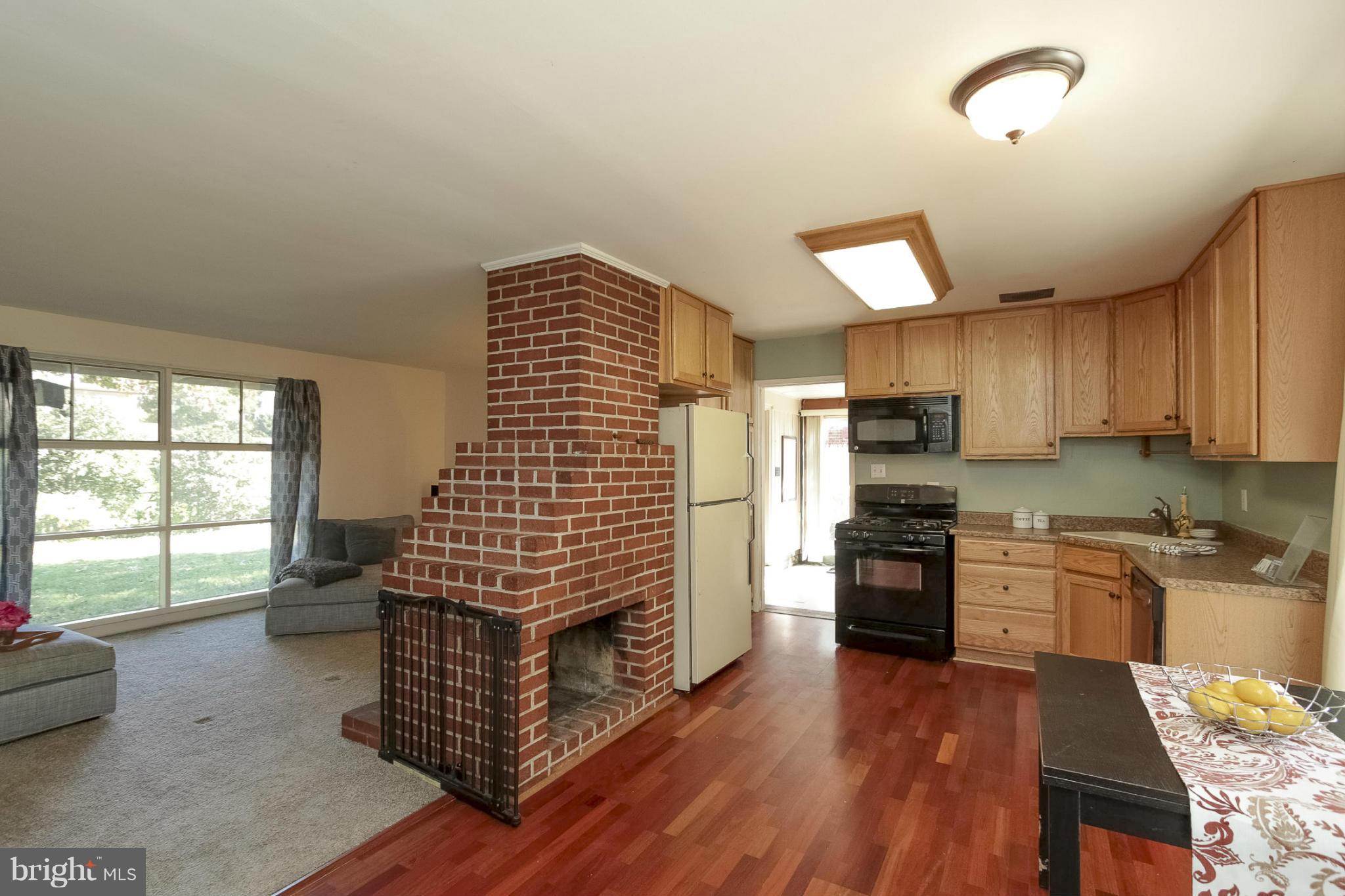 7207 Highland Street Springfield, VA 22150 - Photo 3 of 26 a kitchen with stainless steel appliances kitchen island granite countertop a stove and a refrigerator