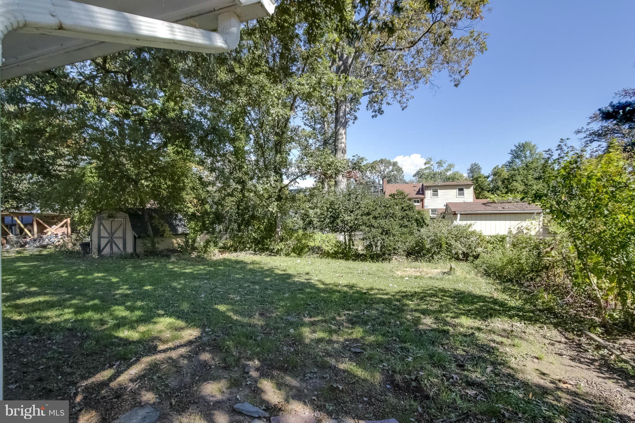 7207 Highland Street Springfield, VA 22150 - Photo 22 of 26 a view of a big yard with plants and large trees