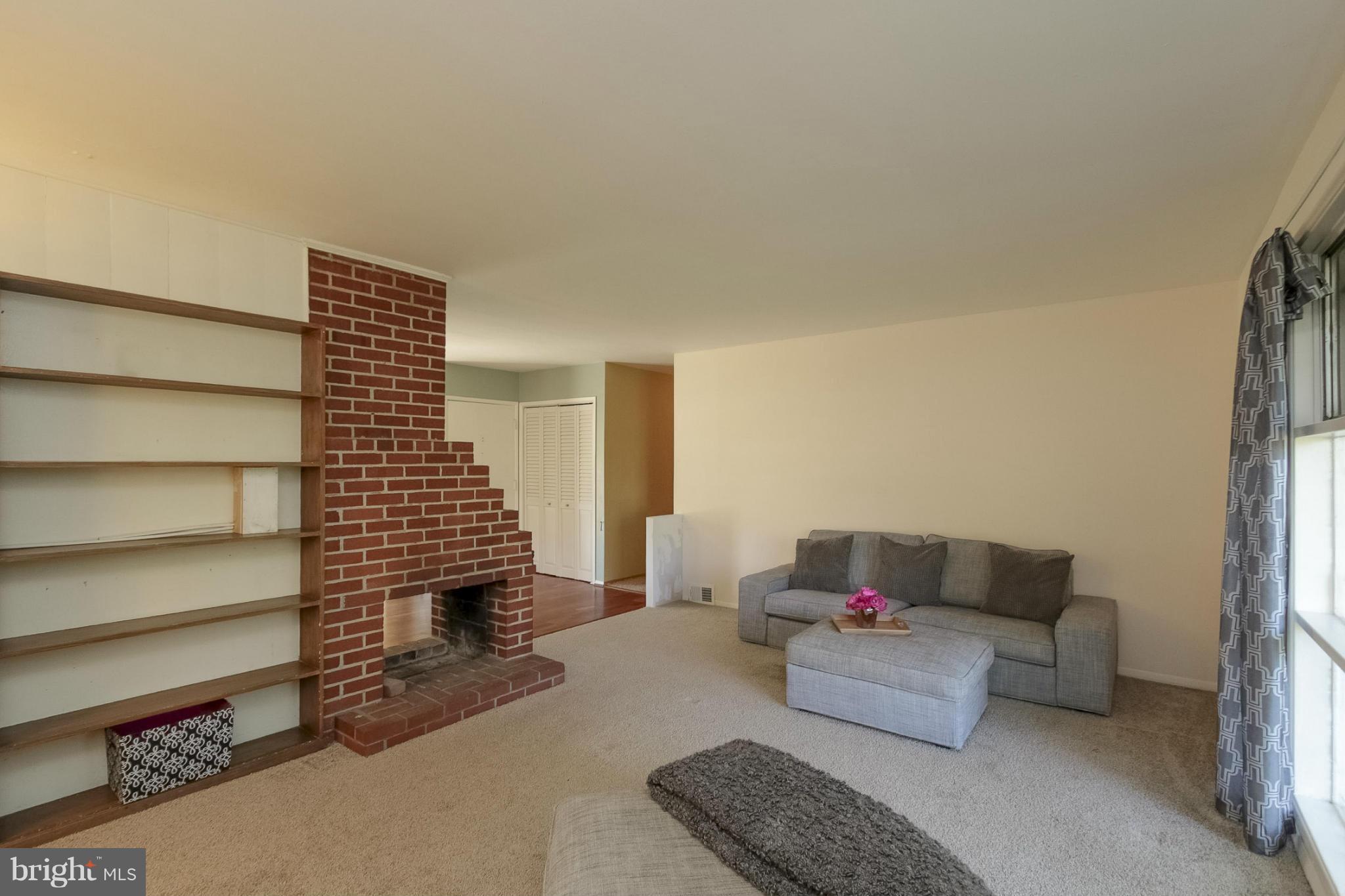 7207 Highland Street Springfield, VA 22150 - Photo 8 of 26 a living room with furniture and a stairs
