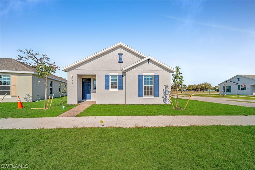 900 Friendship Circle LaBelle, FL 33935 - Photo 1 of 21 a view of a house next to a big yard and large trees