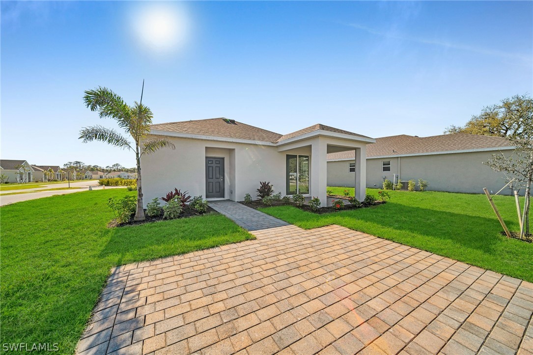 900 Friendship Circle LaBelle, FL 33935 - Photo 19 of 21 a view of a house with a yard and potted plants